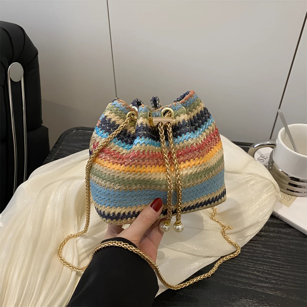 Multicolor straw weave bucket bag with plaid pattern, chain strap, and diamond embellishments