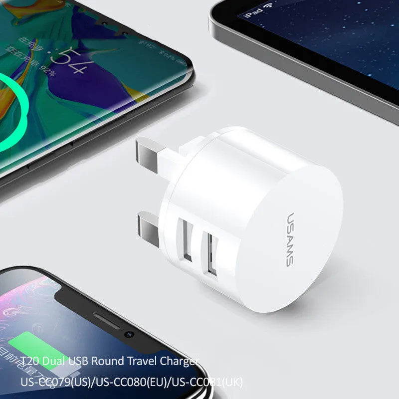 White portable universal dual USB phone charger with US, EU, and UK plug types.