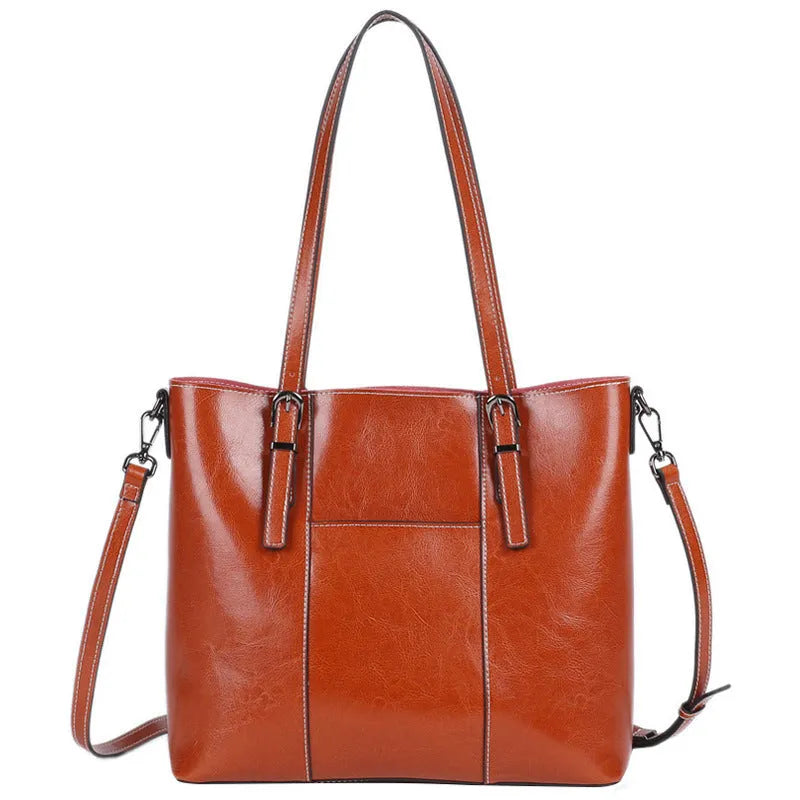 Brown genuine leather retro women's tote bag with multiple zipper pockets and three shoulder straps.