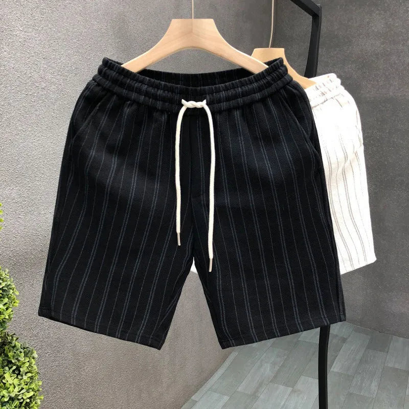 Men's black and white striped fleece-lined casual shorts on a neutral background.