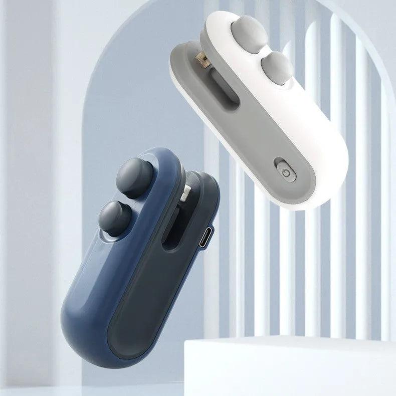 Blue and white handheld USB rechargeable heat sealer for sealing food storage bags on a kitchen counter.