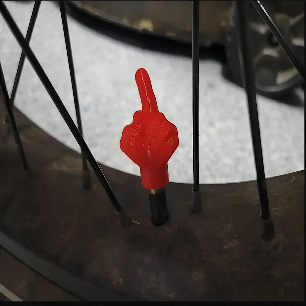 Set of four latex tyre valve caps, showing two skin colour and two black pieces, for car wheel protection.