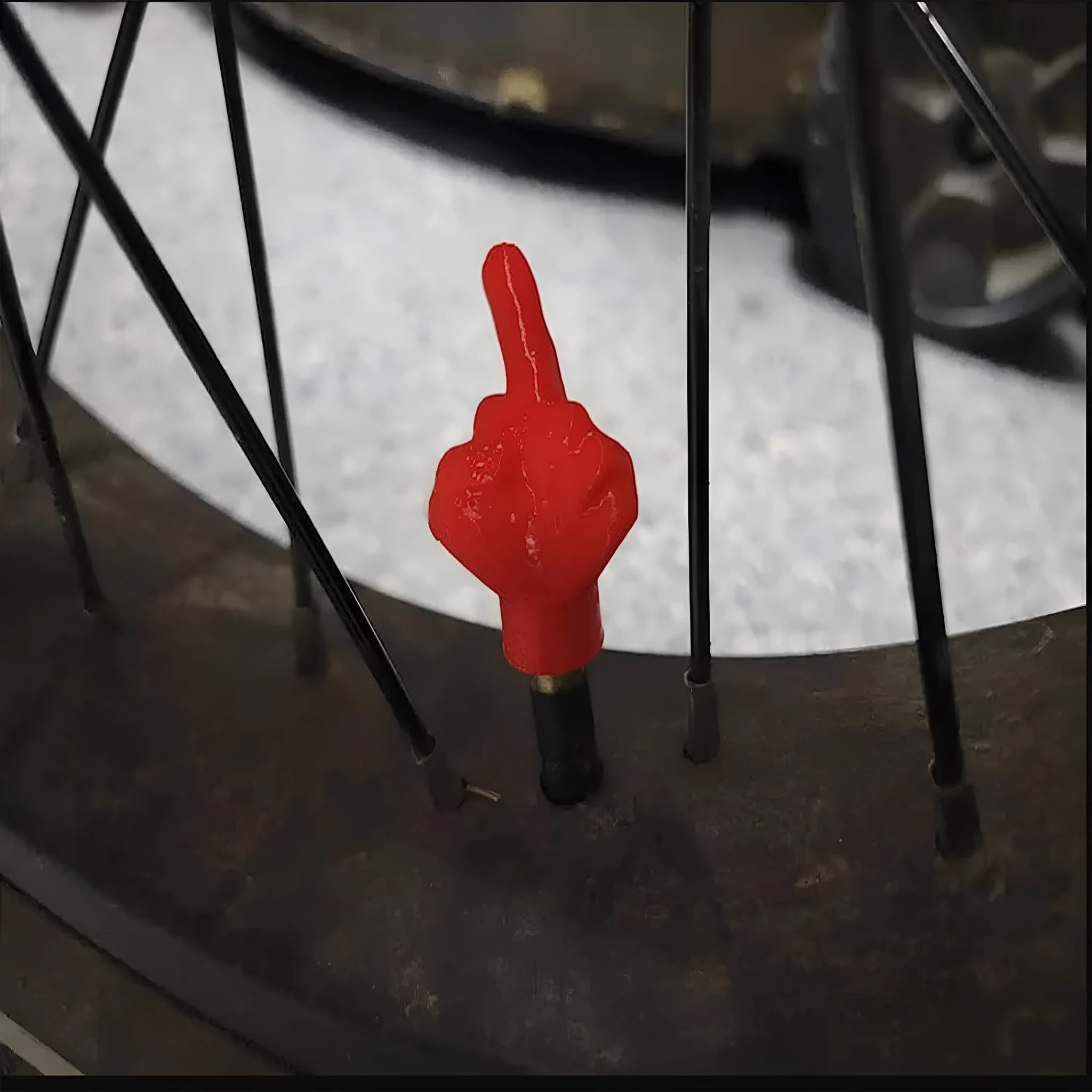 Set of four latex tyre valve caps, showing two skin colour and two black pieces, for car wheel protection.