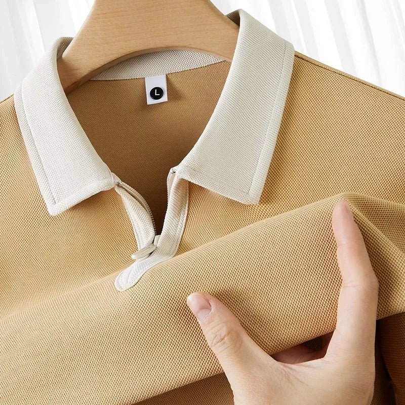 Short sleeve polo shirt with a zipper and lapel front in a solid colour, showing loose fit.