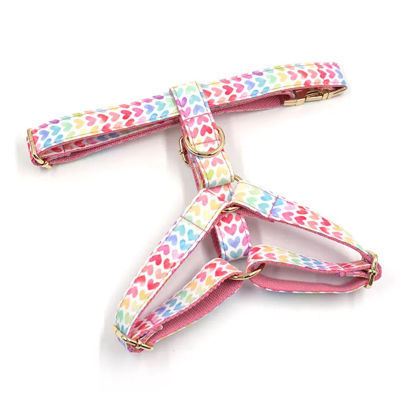 Pink colourful dog harness with heart-shaped stones and gold buckle fastenings on chest and back support design