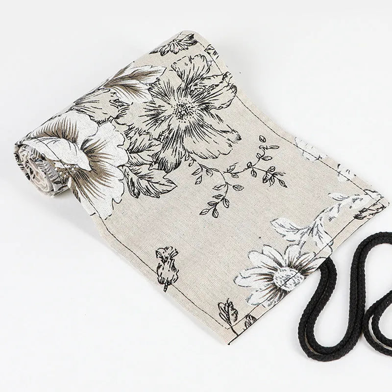 Black peony floral print canvas pencil roll bag open to show multiple tool holes.