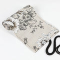 Black peony floral print canvas pencil roll bag open to show multiple tool holes.