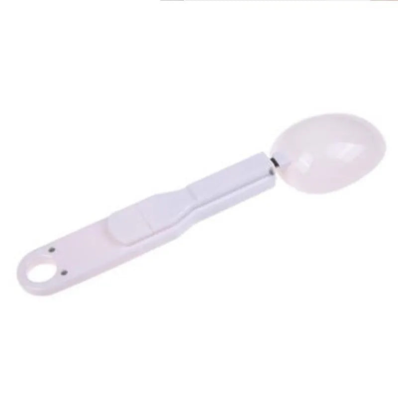 White digital spoon scale with LCD display showing weight measurement for kitchen use