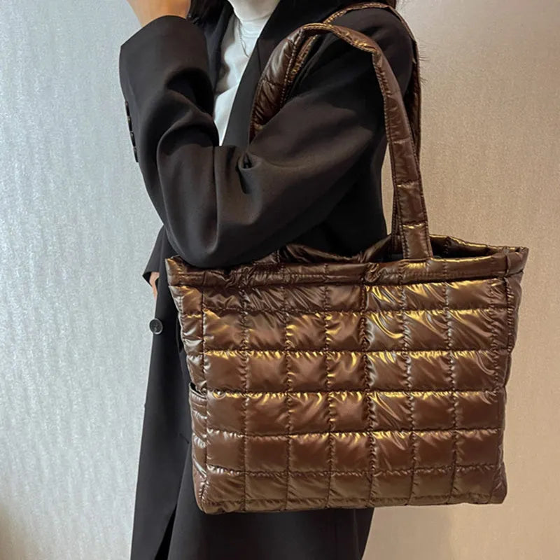 Large nylon plaid bucket shoulder bag in black with rhombus pattern, magnetic buckle, and soft handle.
