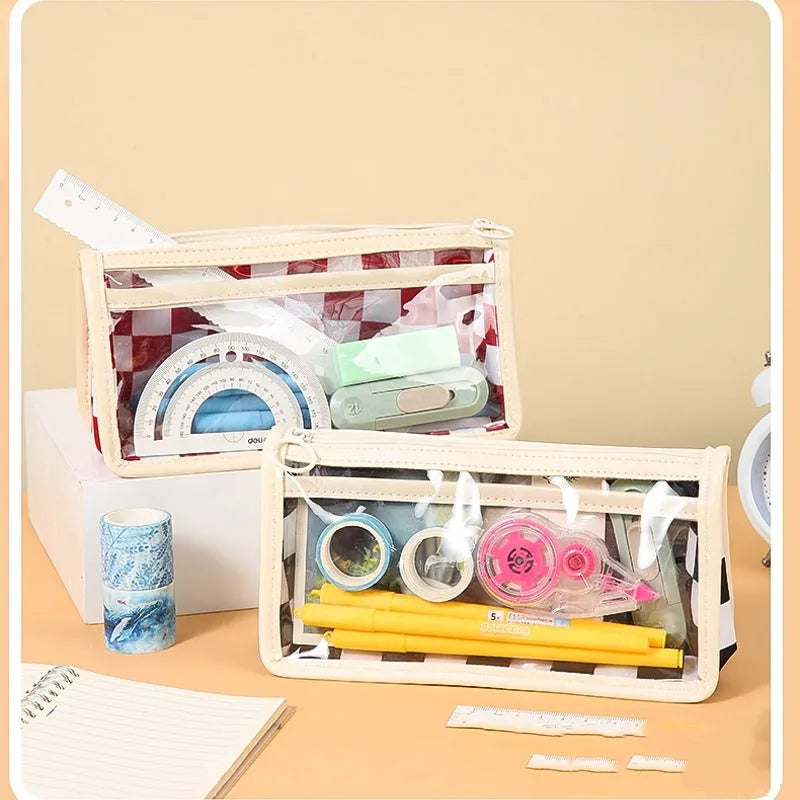 Transparent PVC pencil case with a chessboard grid pattern, showing pens inside.