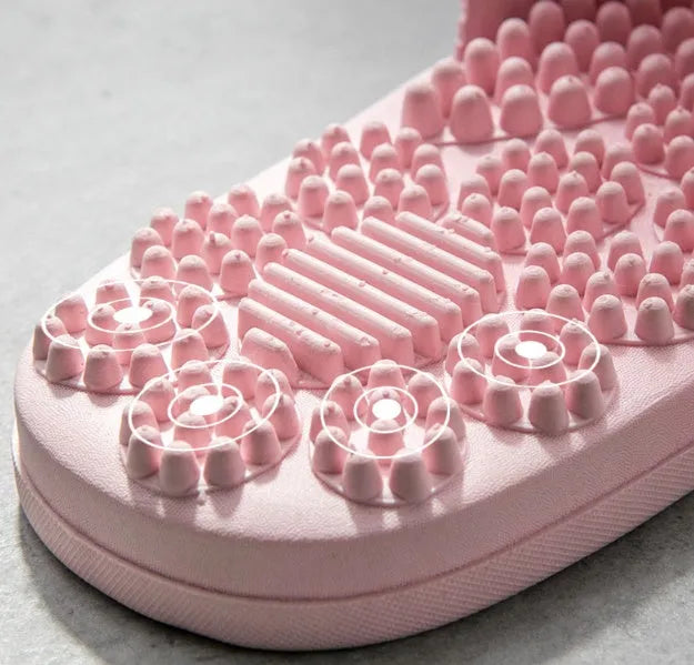 Pair of reflexology foot massage slippers with 3D acupressure particles, blue colour, on a light background