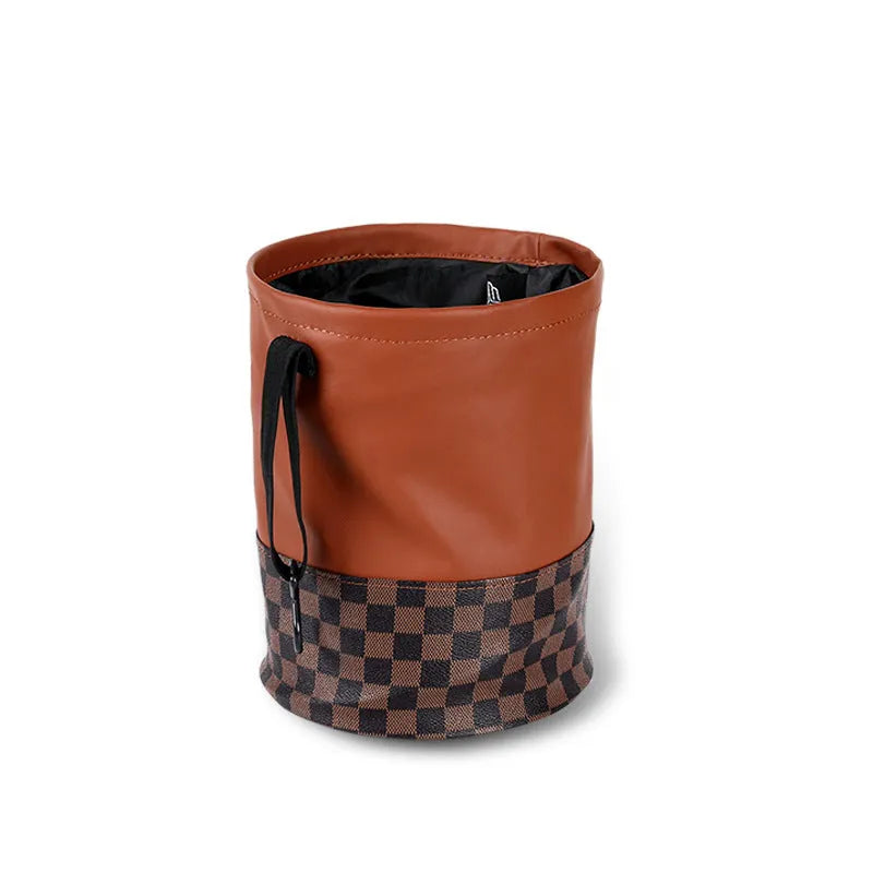Leather retractable car trash can shown in folding design with carry handle