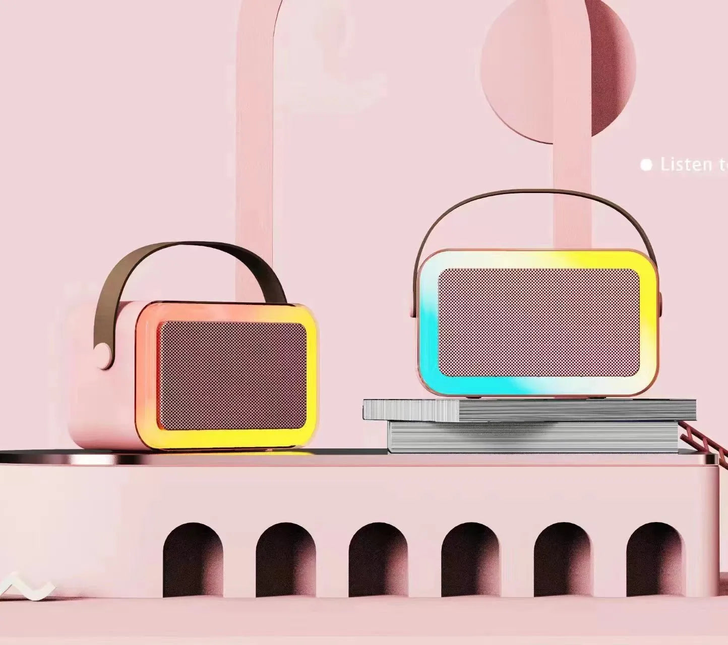 Pink portable Bluetooth speaker with microphone and coloured LED lights on a table.