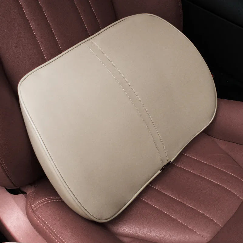 Car seat cushion headrest with memory foam interior and leather exterior in solid colour