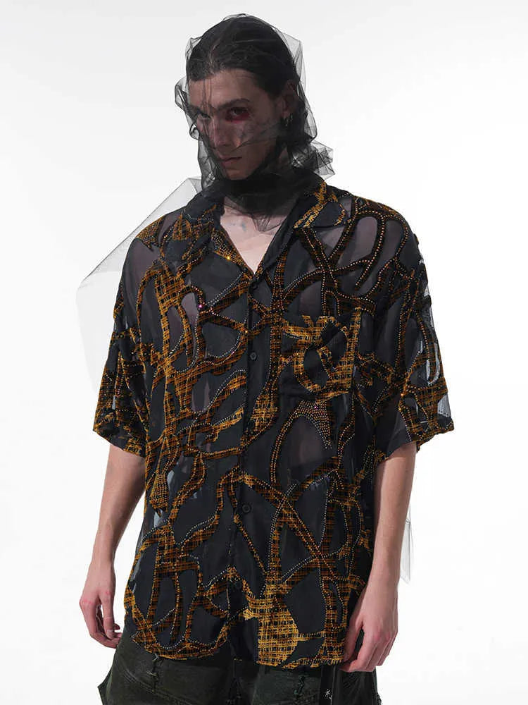 Man's black and grey snake pattern short-sleeved shirt with loose fit and lapel collar.