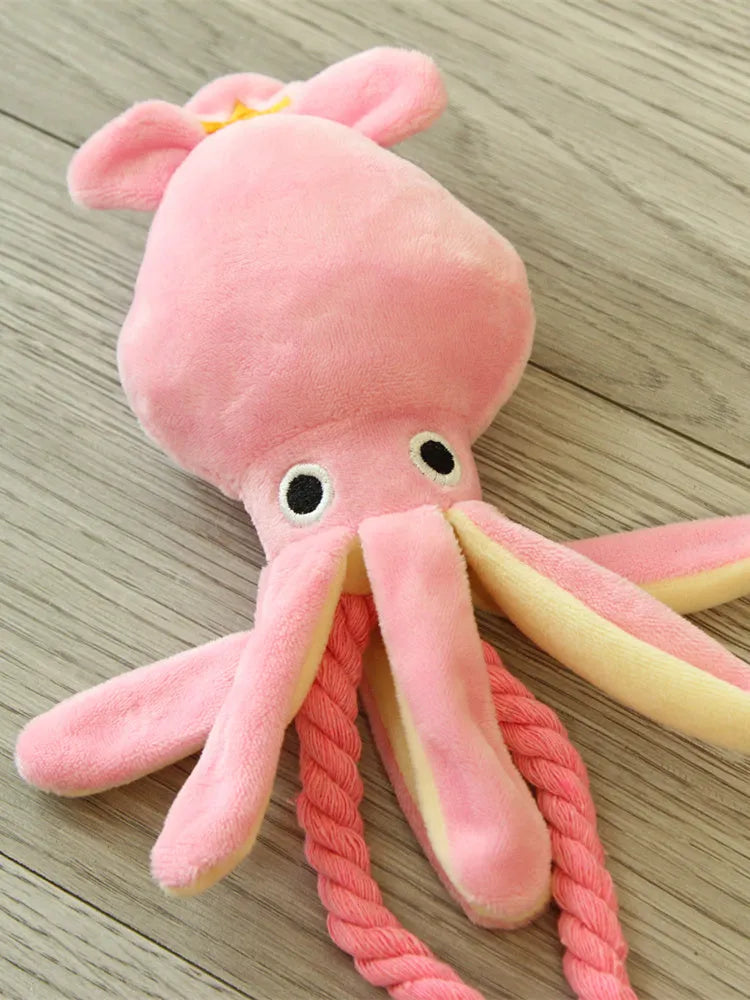 Pink octopus pet plush toy rope toy for dogs with soft fabric head and rope body on white background