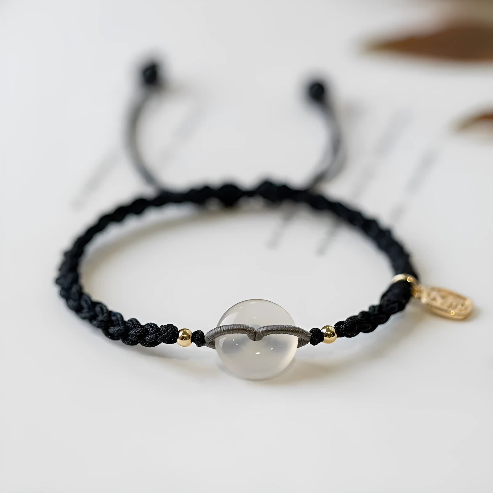 Crystal bracelet with weaving construction and ethnic style design featuring flower-shaped accents on rope strap