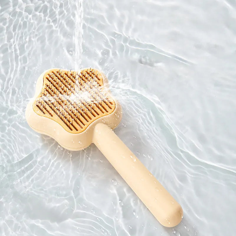 Green self-cleaning cat comb with stainless steel needle teeth and 20 cm handle