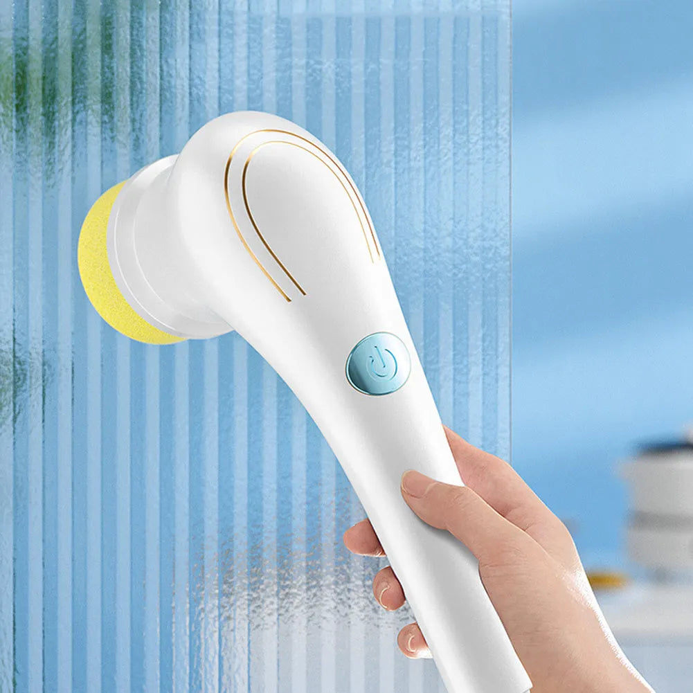 White cordless electric handheld spin scrubber with five different cleaning brush heads and a USB charging cable.