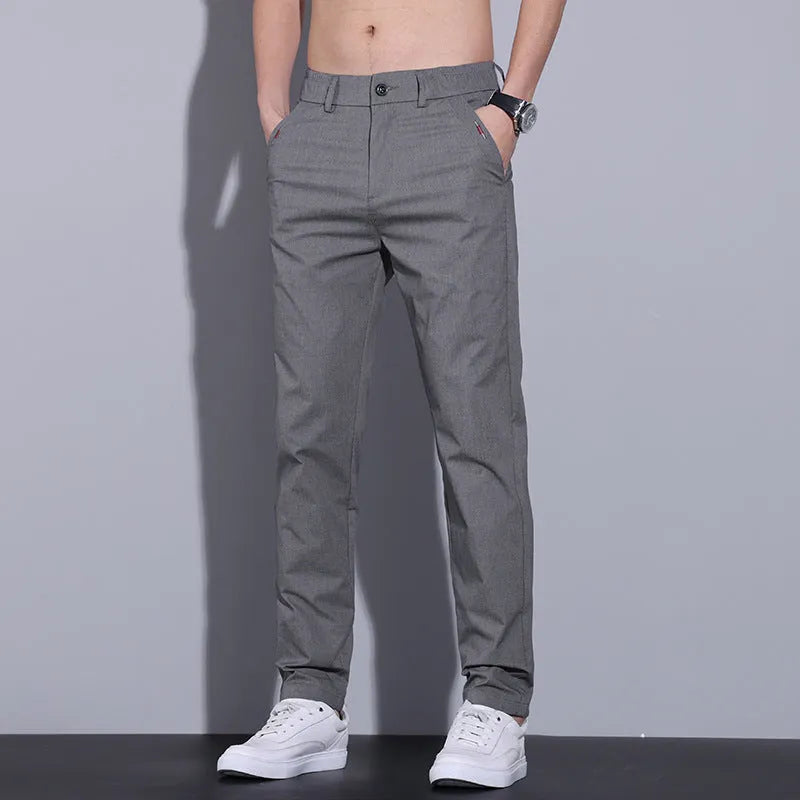 Men's light khaki straight fit cotton casual trousers laid flat, showing slim business casual styling.