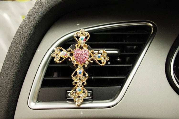 Alloy car fragrance clip with decorative charm attached to car air vent