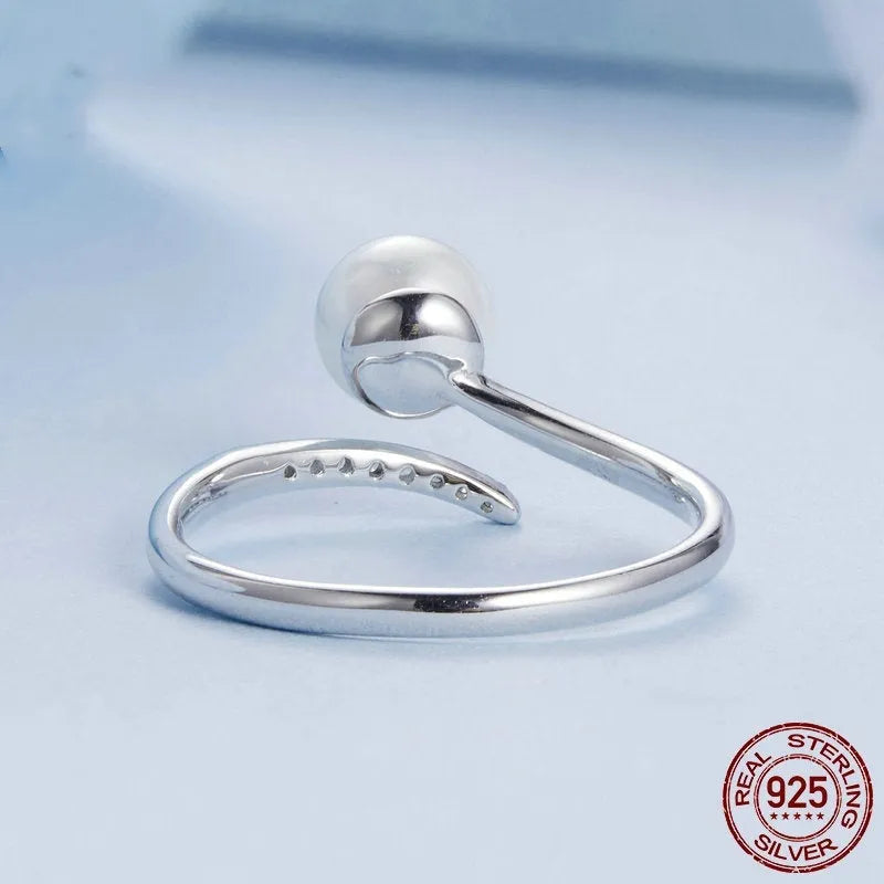Adjustable S925 sterling silver ring with shell pearl centrepiece and open loop design