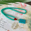 Turquoise mesh flower lucky pendant necklace on an adjustable ball bead chain.