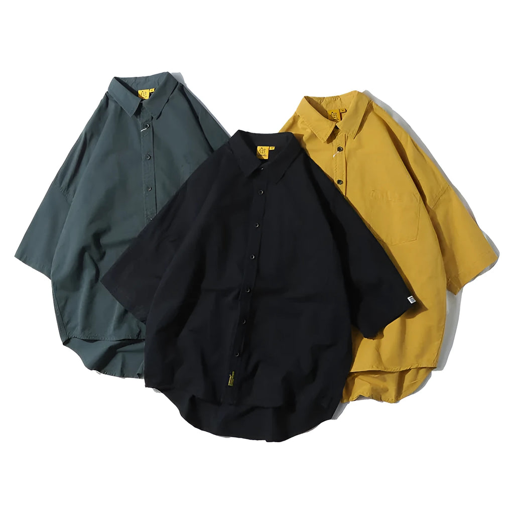 Men's loose-fit cotton cardigan shirt in solid colours on a hanger.