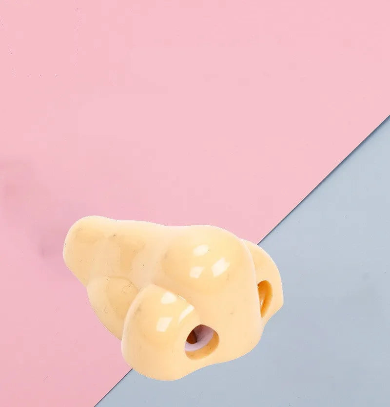 Flesh colour plastic manual pencil sharpener with big nostril and geometry shape.