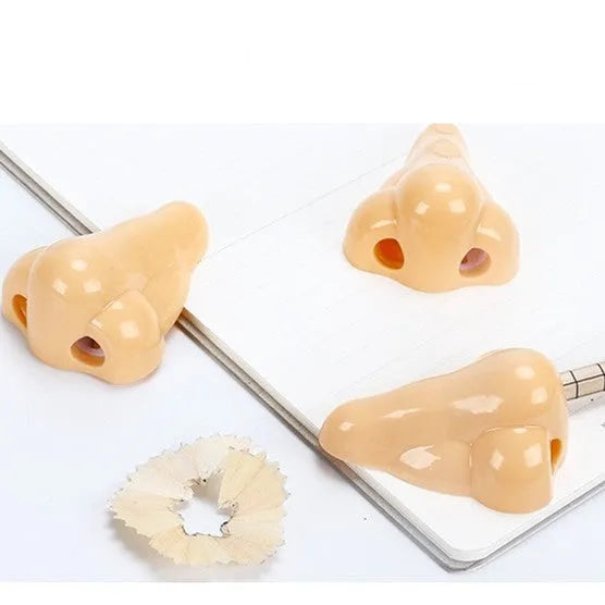 Flesh colour plastic manual pencil sharpener with big nostril and geometry shape.