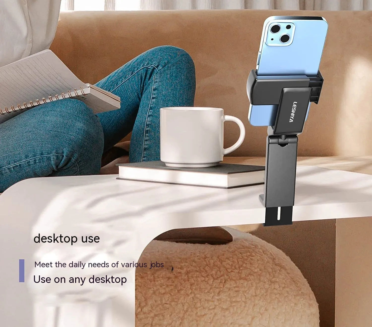 Black foldable and rotating universal mobile phone holder made from ABS plastic on a flat surface.