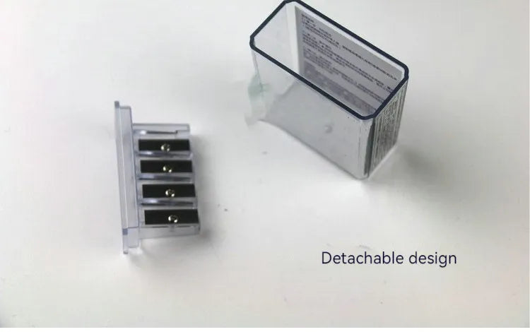 Geometric four-hole plastic pencil sharpener with spare blades and a screwdriver on a white background