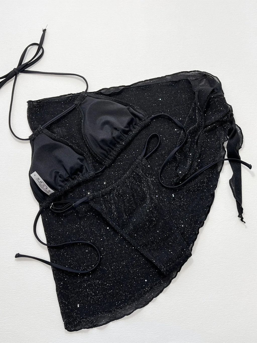 Black women's three-piece bikini swimsuit set with top and shorts on a mannequin.