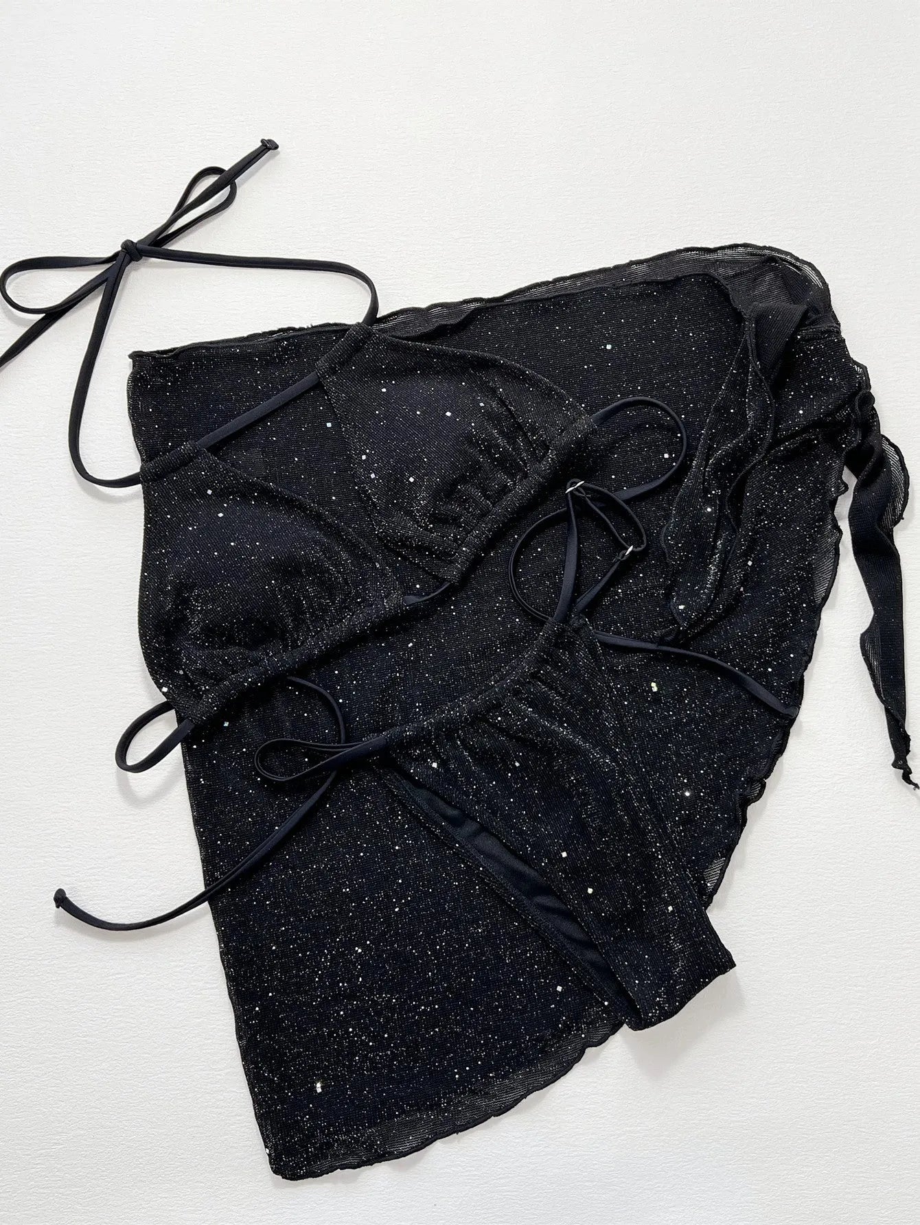 Black women's three-piece bikini swimsuit set with top and shorts on a mannequin.