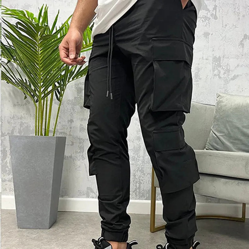 Men's stretch nylon ankle banded slacks in black, side view, plain colour design