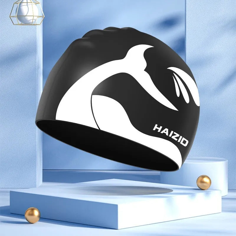 Silicone swimming cap with whale tail pattern and built-in ear protectors in choice of colours