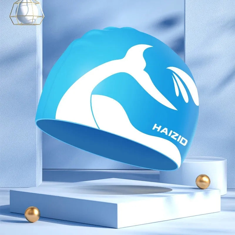 Silicone swimming cap with whale tail pattern and built-in ear protectors in choice of colours