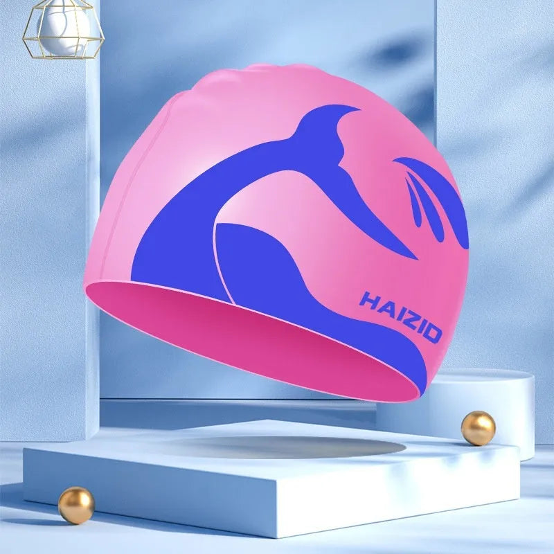 Silicone swimming cap with whale tail pattern and built-in ear protectors in choice of colours