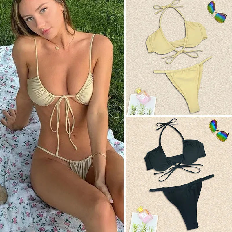 Black and mint green women's nylon bikini swimsuit set on a hanger.