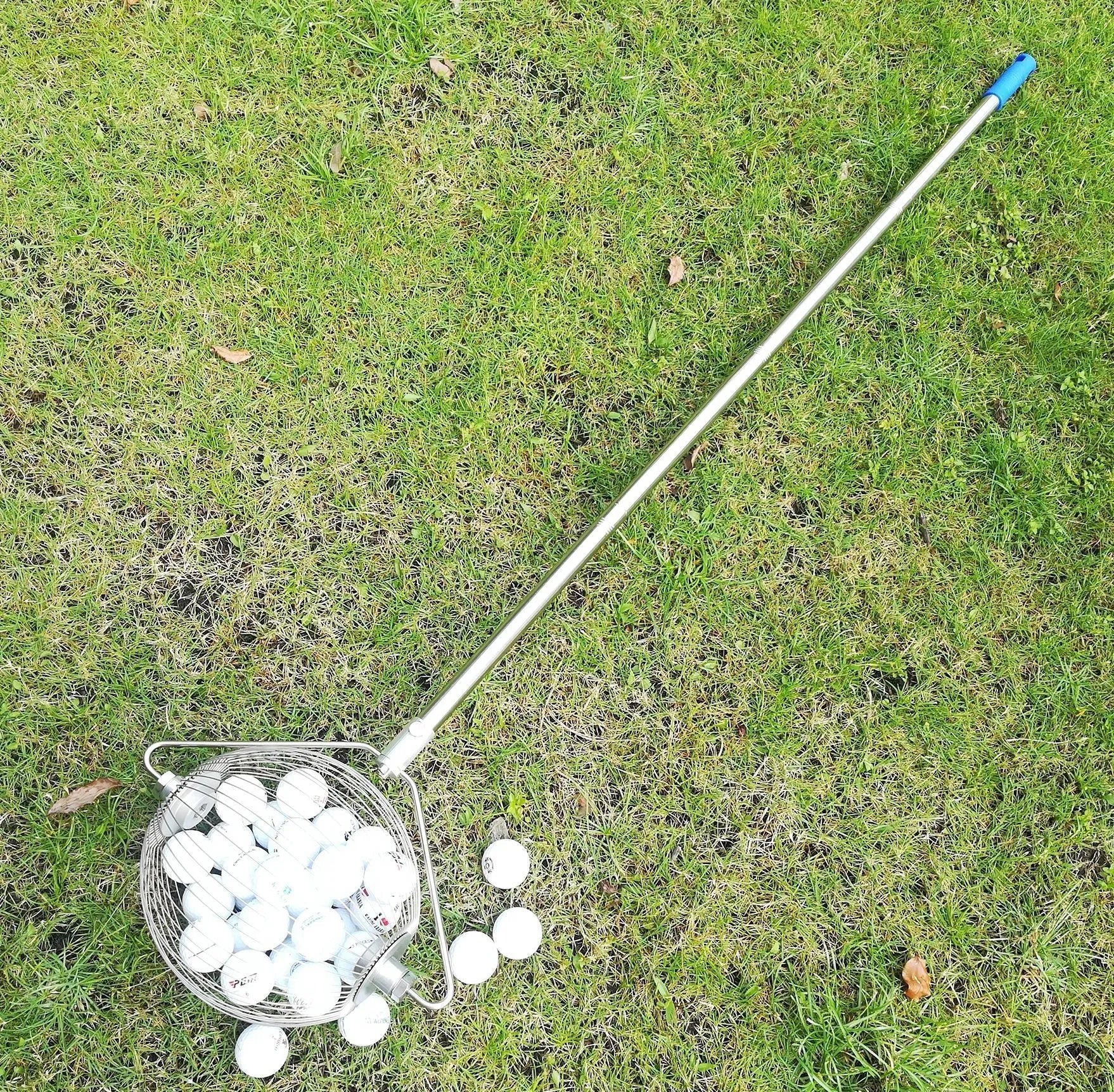 Metallic 304 stainless steel golf ball picker on a green surface.