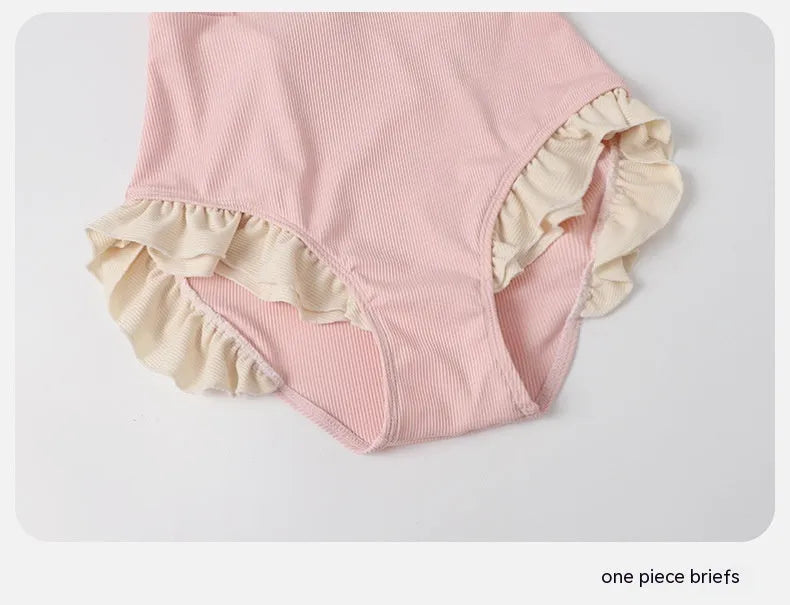 Pink Siamese style conservative one-piece swimsuit for women on a hanger