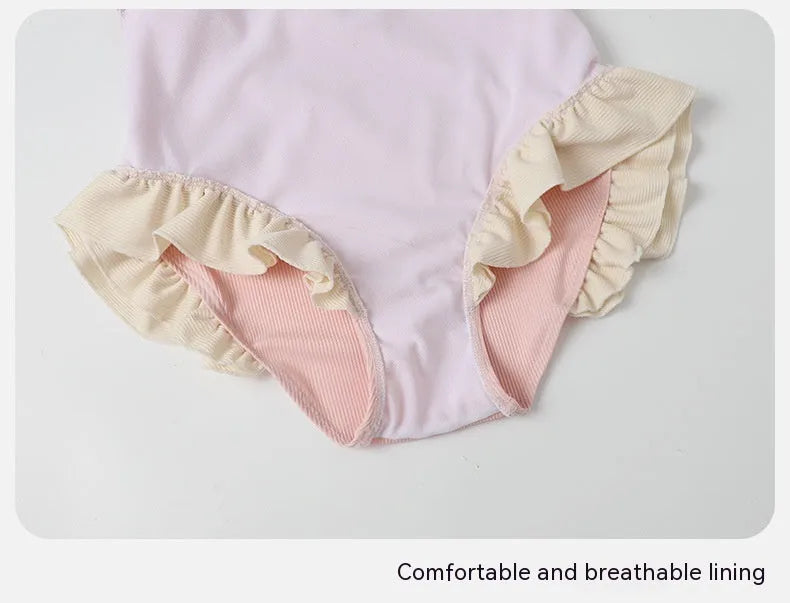Pink Siamese style conservative one-piece swimsuit for women on a hanger