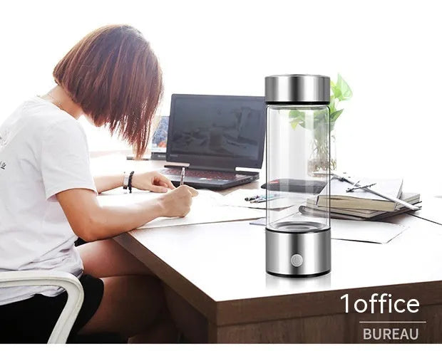 Silver hydrogen water bottle with electric generator, borosilicate glass cylinder.