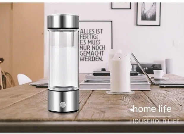 Silver hydrogen water bottle with electric generator, borosilicate glass cylinder.