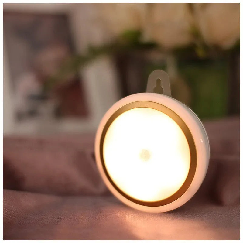 Round white motion sensor LED light unit, 80mm in diameter, for wardrobes and corridors.