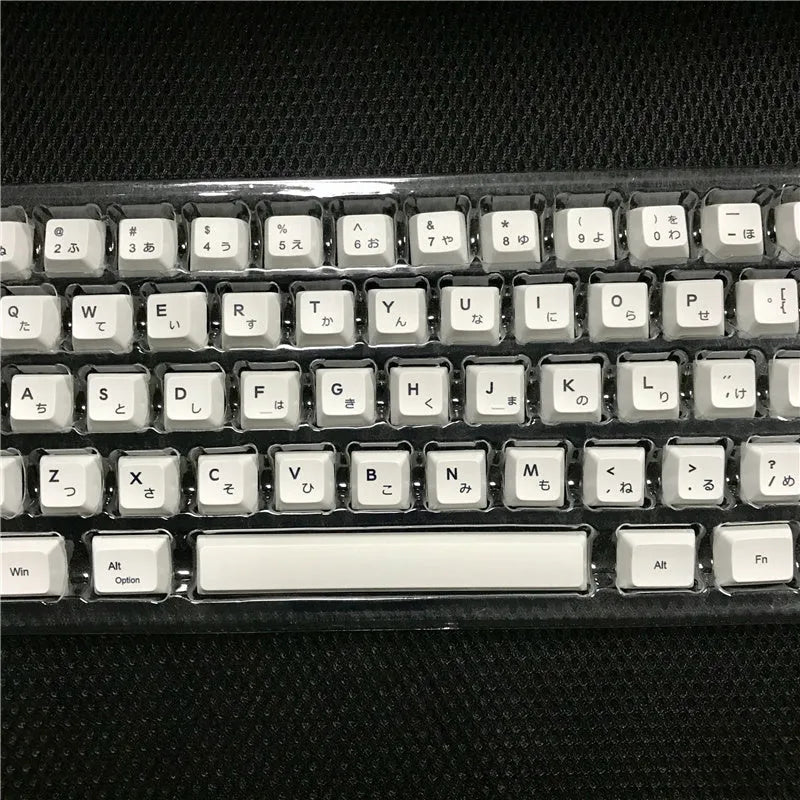 White Japanese keycap set with 100 PBT keycaps featuring sublimated character legends for mechanical keyboards