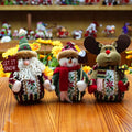 Set of red, green, and white flannel Christmas ornaments showing snowman, elk, and old man designs.