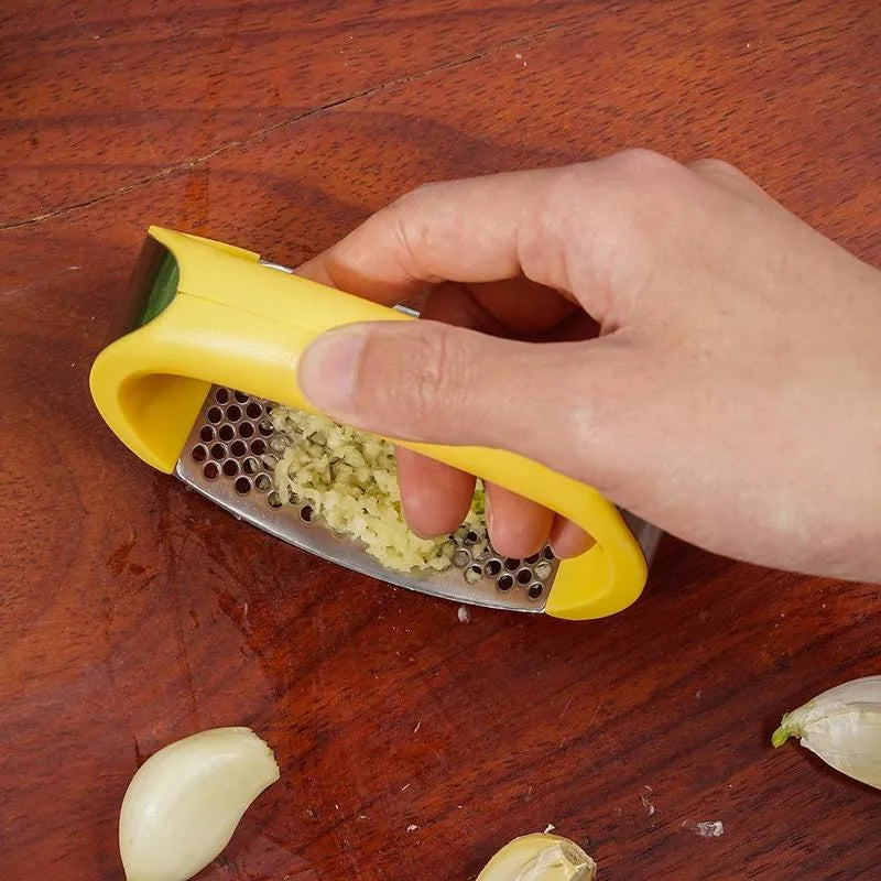 Stainless steel manual garlic press with ergonomic non-slip handle in assorted colours