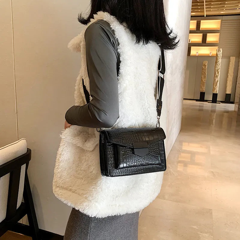 Vintage PU leather crossbody bag in black showing interior organisation for phones and wallets