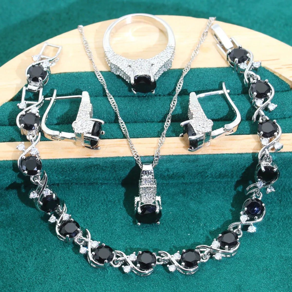 Bridal zircon jewellery four-piece set showing necklace, bracelet, earrings and ring with water wave chain